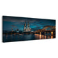 Kölner Dom mit beleuchteter Brücke am Abend Wandbild